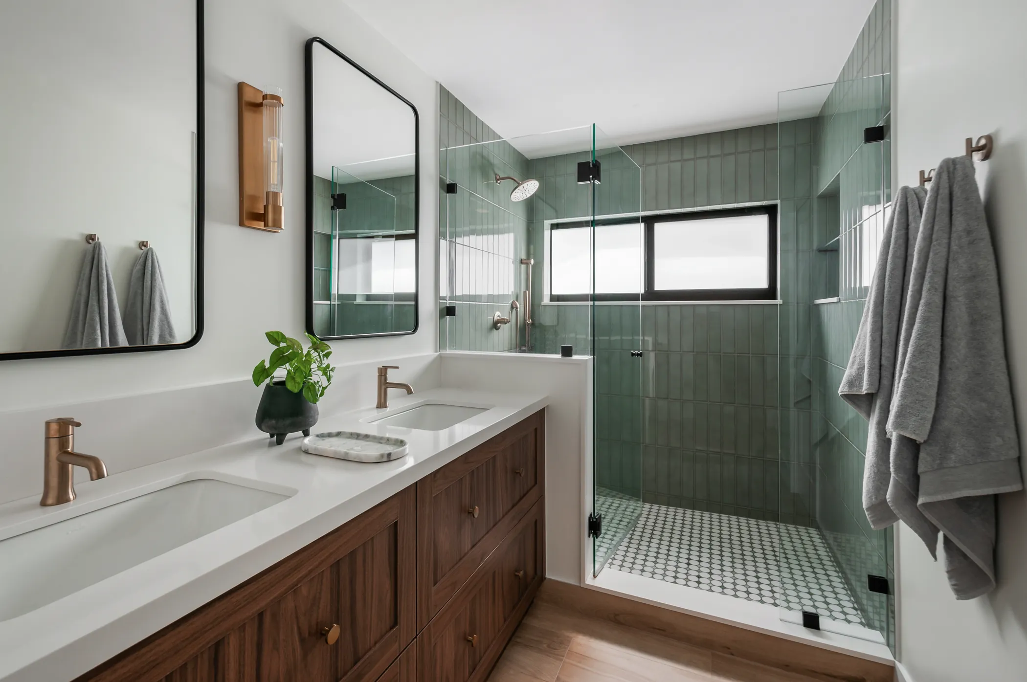 Master bath with walnut double vanity and green tile shower