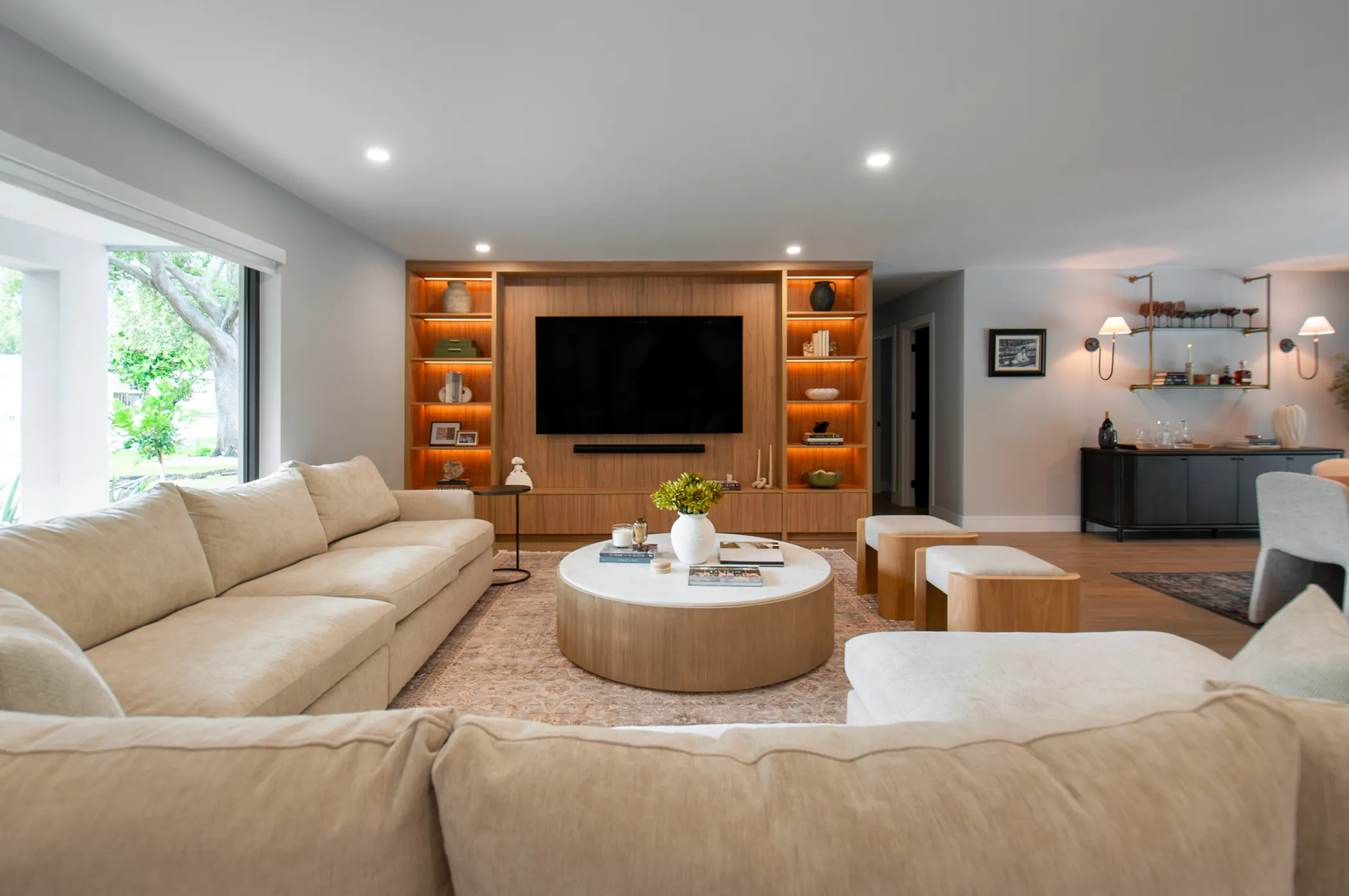 Family room with custom TV unit and warm-lit shelving