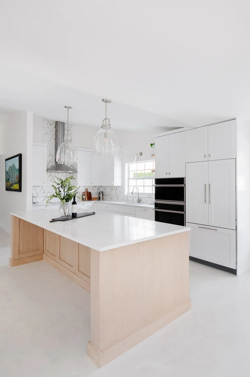 Kitchen island and paneled fridge wall