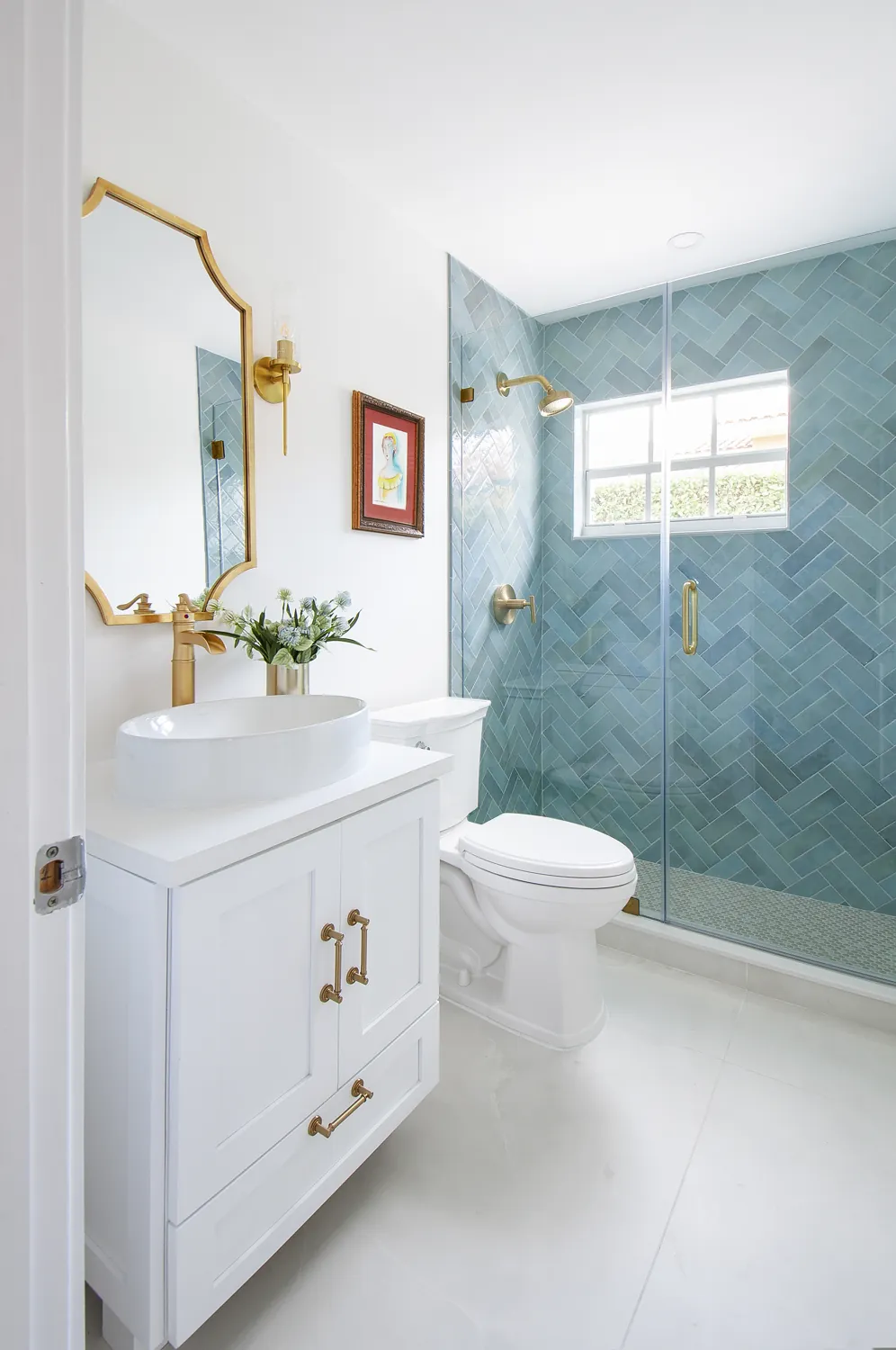 Guest bath with blue herringbone shower and brass