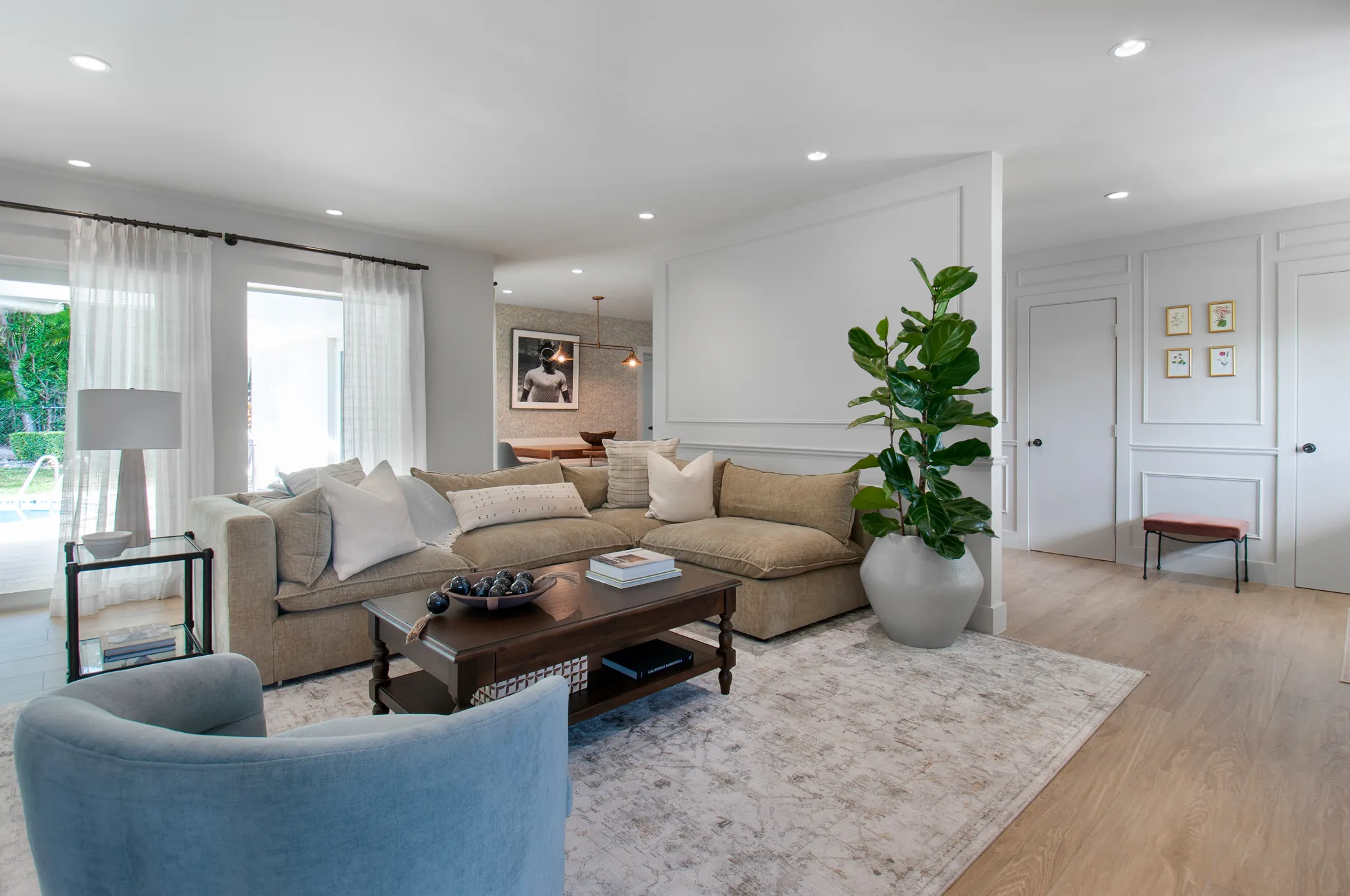 Living room with panel molding and layered neutrals