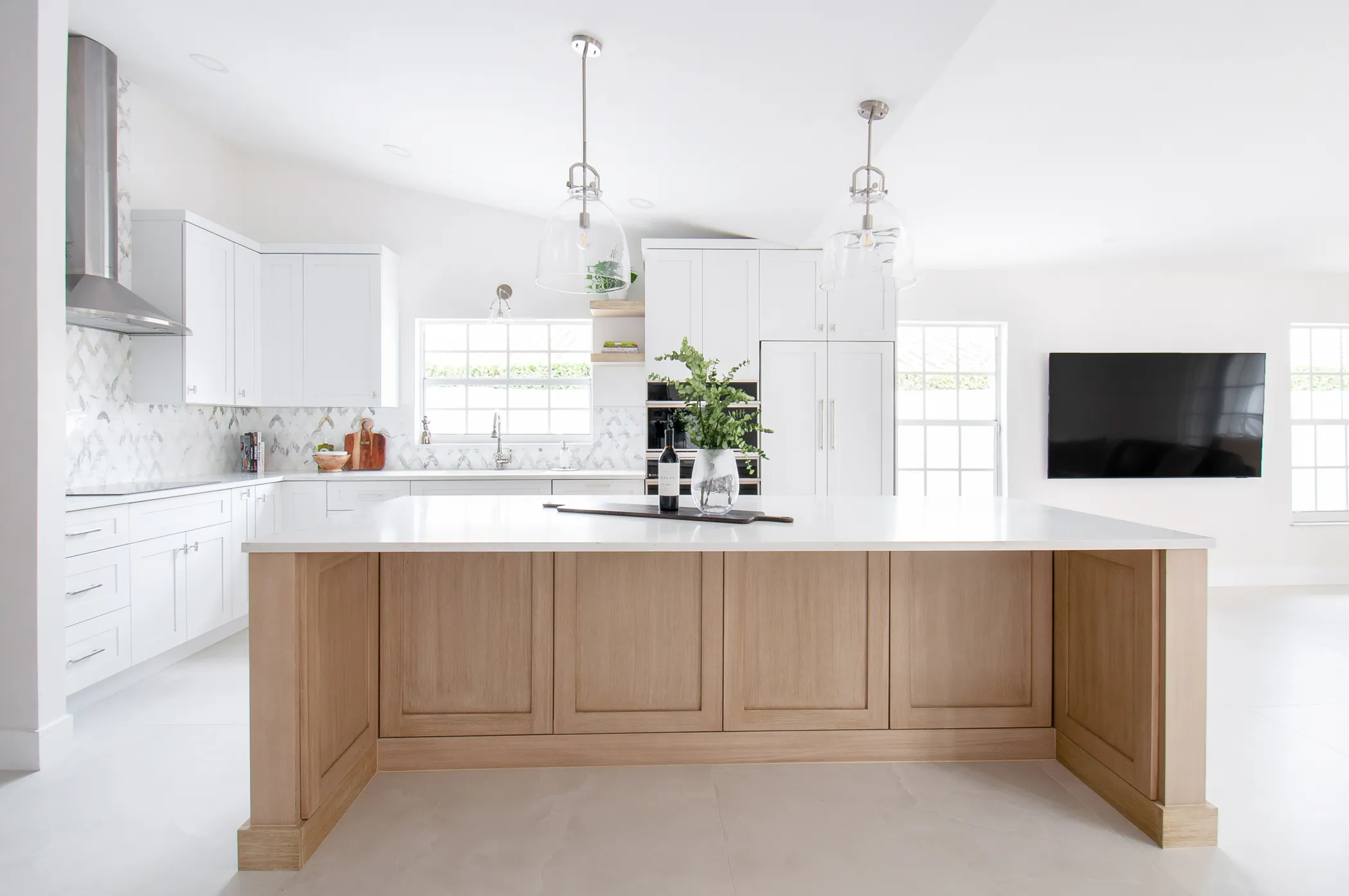 White kitchen with oak island