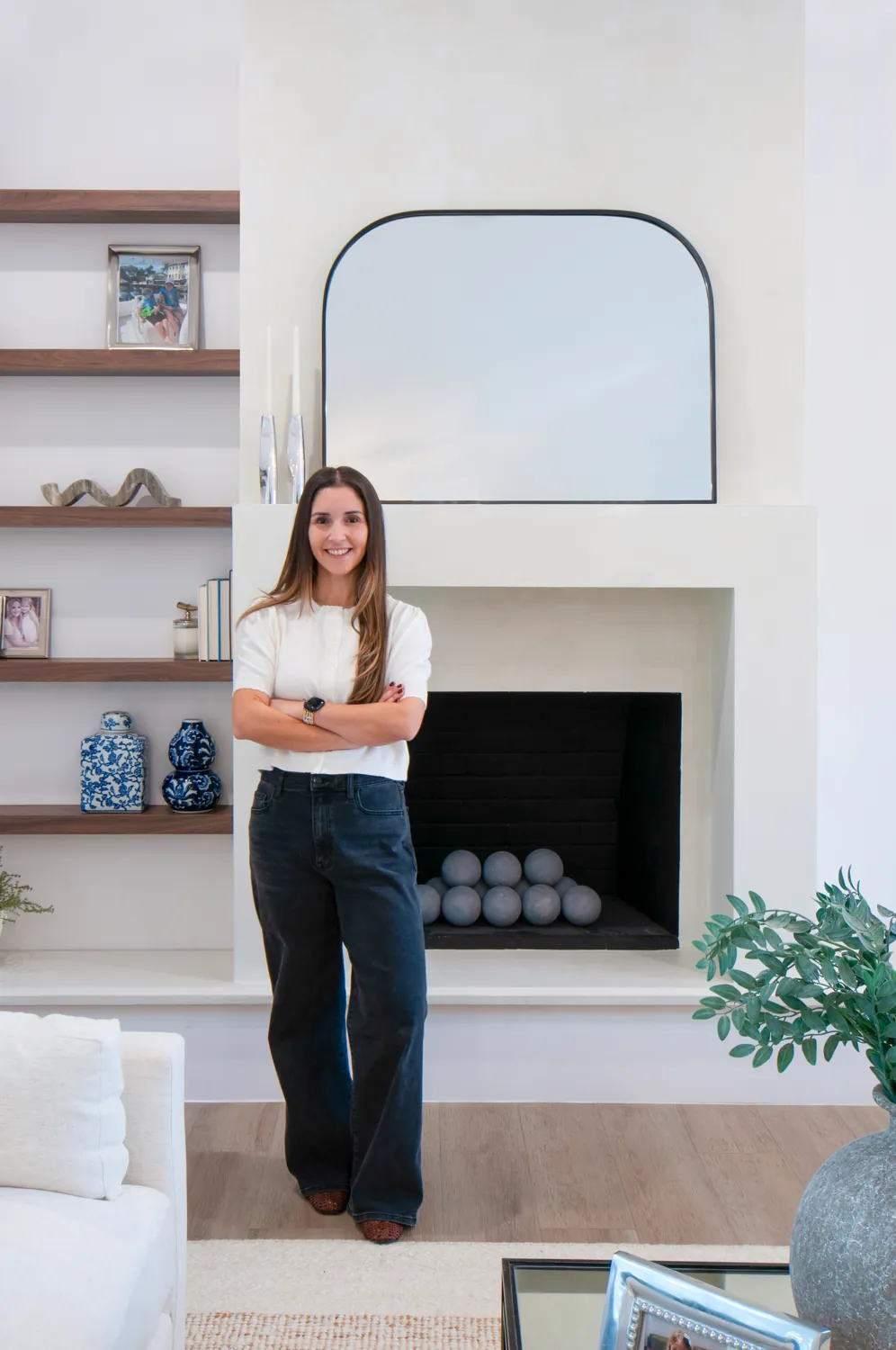 Camila beside the plaster fireplace