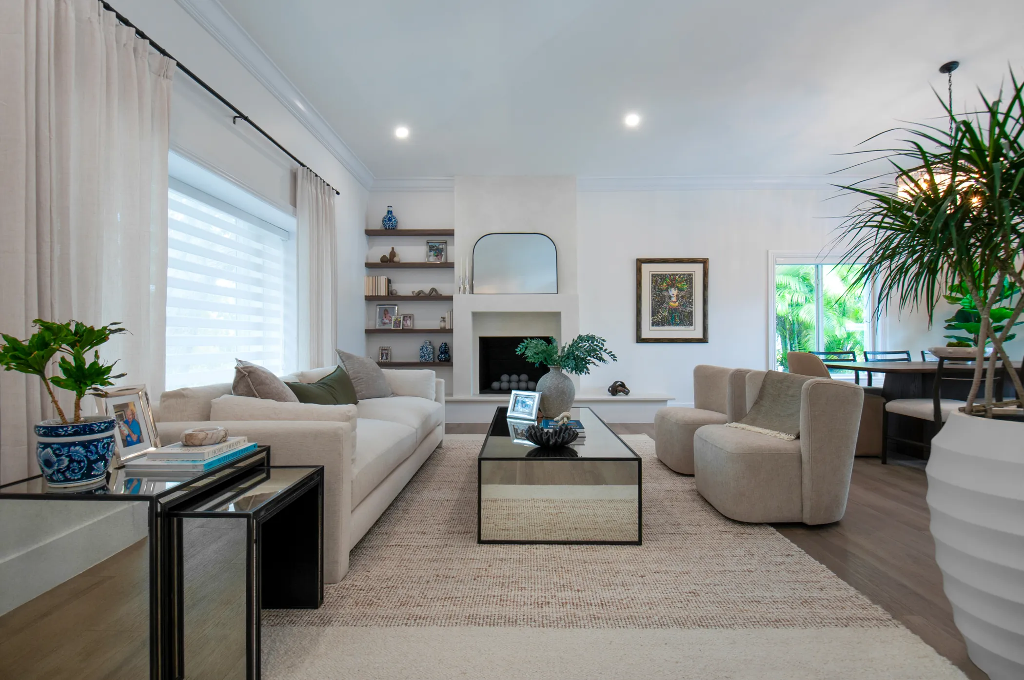 Living room toward the fireplace and shelving, dining beyond